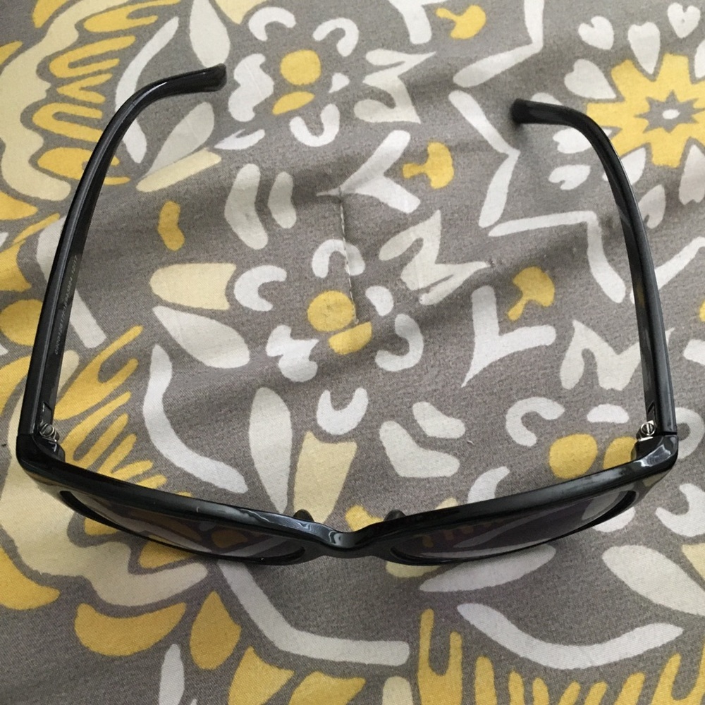 Black sunglasses with purple tint.